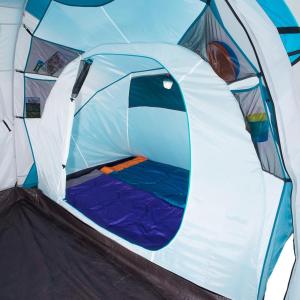 a white tent with a bed inside of it at Gopeng Campsite in Gopeng