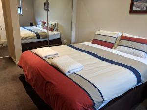 two beds in a hotel room with towels on them at Blues Air 3 in Thredbo