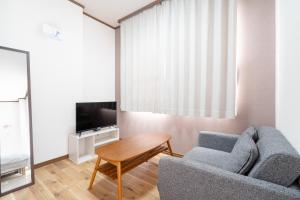 a living room with a couch and a table at Kent Clair Ishigaki Bay in Ishigaki Island