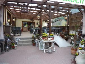 a patio with tables and chairs in a building at Landgasthaus Am Frauenstein in Hinterweidenthal