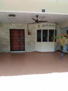 a living room with a ceiling fan and a door at KERAI GUEST HOUSE TEMERLOH in Kampong Telok Mengkuang