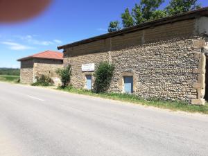 um edifício de tijolos na berma de uma estrada em STUDIO INDEPENDANT ET TINY HOUSE DANS FERME 18ème em Saint-Michel-sur-Savasse