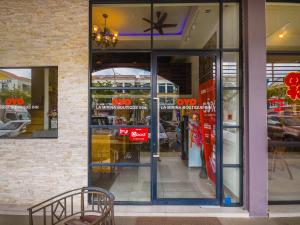 OYO 1023 La Mirina Boutique Inn في ميري: واجهة محل والابواب مفتوحة في محل