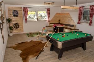 a living room with a pool table in a room at Ferienhof Settele in Bad Wörishofen