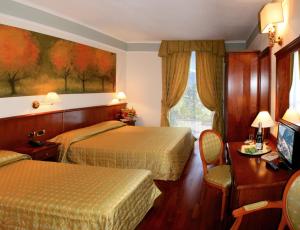 Postel nebo postele na pokoji v ubytování Hotel Astra