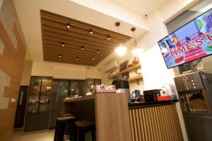 a fast food restaurant with a bar and a tv at Ai's Inn in Magong