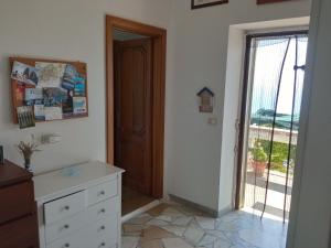 a room with a dresser and a door with a window at GIARDINO SUL MARE in Amalfi