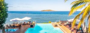 a swimming pool with a view of the ocean at Hotel Sakouli in Bandrélé
