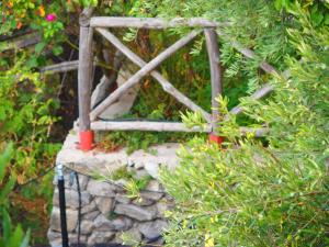 a small wooden bridge on top of a stone wall at GIARDINO SUL MARE in Amalfi