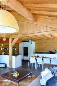 a living room and kitchen with a couch and a table at Grand chalet Le Trappeur - Chamonix in Chamonix