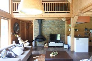 a living room with a couch and a stove at Grand chalet Le Trappeur - Chamonix in Chamonix