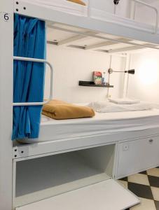 a room with a bunk bed with a blue curtain at Soul Backpackers Barcelona in Barcelona