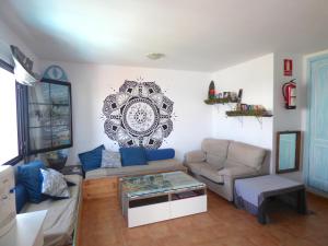 a living room with a couch and a table at La Fresa Hostel in Corralejo