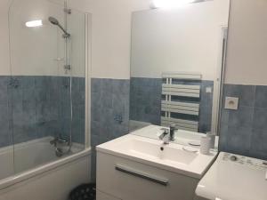 a bathroom with a sink and a shower and a tub at Ste Cécile Plage in Camiers