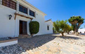 a white house with trees and a driveway at Cortijo Boutique Marbella in Marbella