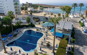 an aerial view of a resort with a pool and a beach at Anonymous Beach Hotel (Adults 16+) in Ayia Napa