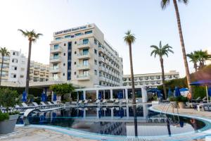 a hotel with a swimming pool and palm trees at Anonymous Beach Hotel (Adults 16+) in Ayia Napa