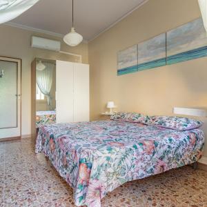 a bedroom with a large bed in a room at Appartamento Marco Polo in Viareggio