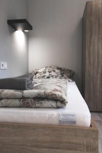 ein Bett mit einer hölzernen Plattform in einem Zimmer in der Unterkunft Füzeskerti Apartmanház in Békésszentandrás