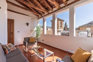 a living room with a couch and a table at San José Apartments in Granada