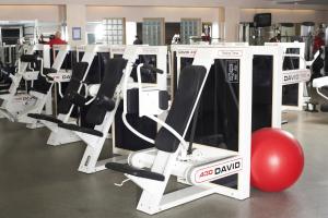 a row of machines in a gym with a red ball at Neptun Hotel in Saint Petersburg
