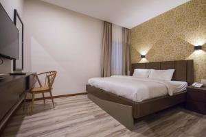 Postel nebo postele na pokoji v ubytování Wifi Boutique Hotel