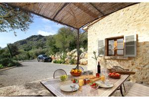 a table with fruit on it in front of a building at Can Suau Dalt in El Port