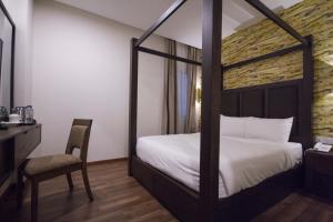 Postel nebo postele na pokoji v ubytování Wifi Boutique Hotel