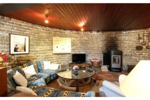 a living room with couches and a brick wall at El Bikoro in Port de Pollensa