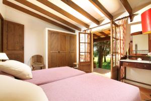 a bedroom with two beds and a fireplace at El Bikoro in Port de Pollensa +67 photos