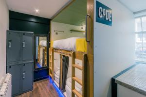 a room with a bed, a refrigerator, and a window at CoDE Co-Living – The LoFT - Edinburgh in Edinburgh