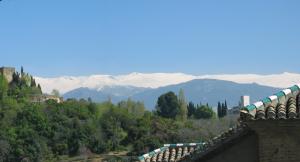 a view of snow capped mountains from a building at San José Apartments in Granada