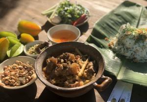 a bowl of food on a table with other bowls of food at HOTEL DUY NHẤT 2 in Phú Nhơn