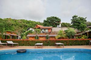 a house with a swimming pool in front of a house at Chom Dao Resort in Ko Lanta