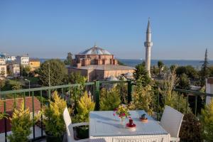 un balcone con tavolo e sedie e un edificio di Sofia Corner Hotel a Istanbul