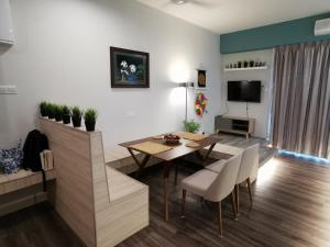 un soggiorno con tavolo, sedie e TV di Zen at Midhills Genting a Resorts World Genting