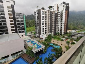 an aerial view of a resort with a pool and buildings at Zen at Midhills Genting in Genting Highlands