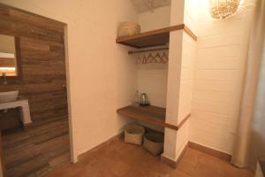 a bathroom with a sink and a wooden wall at InDa hotel in Varkala