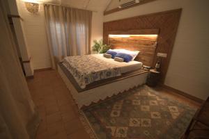 a bedroom with a bed with a wooden headboard at InDa hotel in Varkala