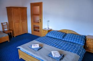A bed or beds in a room at Pension Horalka