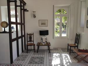 a room with chairs and a table and a window at Château du Parc Soubise en Vendée in Mouchamps