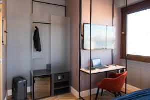 a room with a desk and a chair at B&B Hotel Milano City Center Duomo in Milan