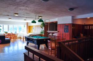 a living room with a pool table in it at Pension Horalka in Špindlerův Mlýn