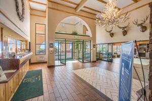 a large lobby with a chandelier and a hallway with glass doors at Quality Inn Kanab National Park Area in Kanab +29 photos