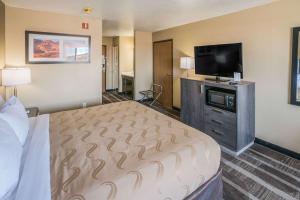 a hotel room with a bed and a flat screen tv at Quality Inn Kanab National Park Area in Kanab