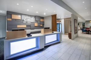 a lobby with a reception desk with boxes on it at Holiday Inn Express & Suites - Chico, an IHG Hotel in Chico