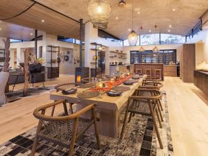 a large wooden table in a room with a kitchen at Perivoli Lagoon House in Stanford
