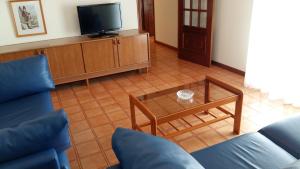 a living room with a couch and a coffee table at Apartamentos Turisticos Arosa Ogrove in O Grove