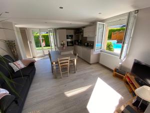 a living room with a couch and a table at Au coeur du Gévaudan appartement de plain pied in Marvejols
