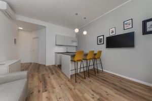 a kitchen and living room with a counter and chairs at Casa da Suite Mirabello in Milan +75 photos